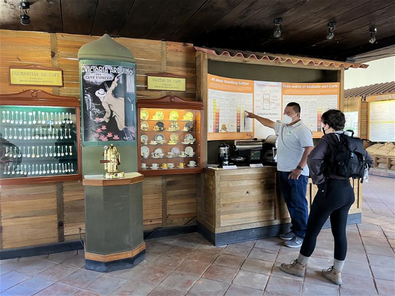 Two individuals posing near a wooden display case in Guatemala.