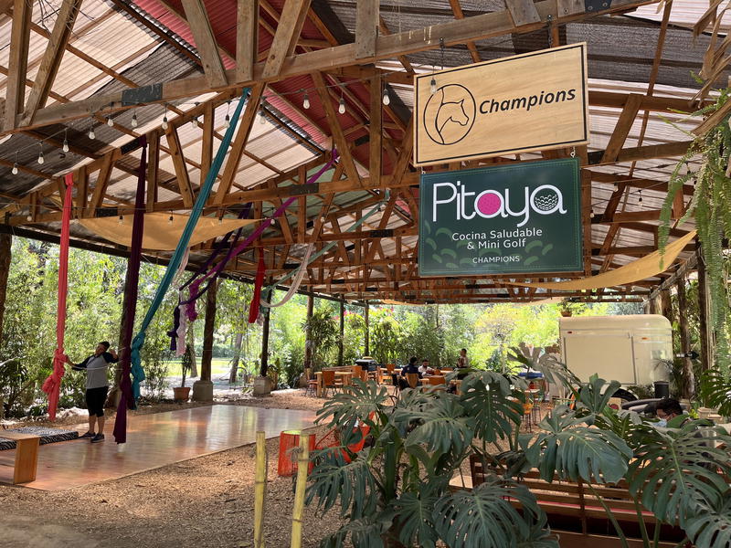 A wooden building in Guatemala with a sign that says pyjaa.