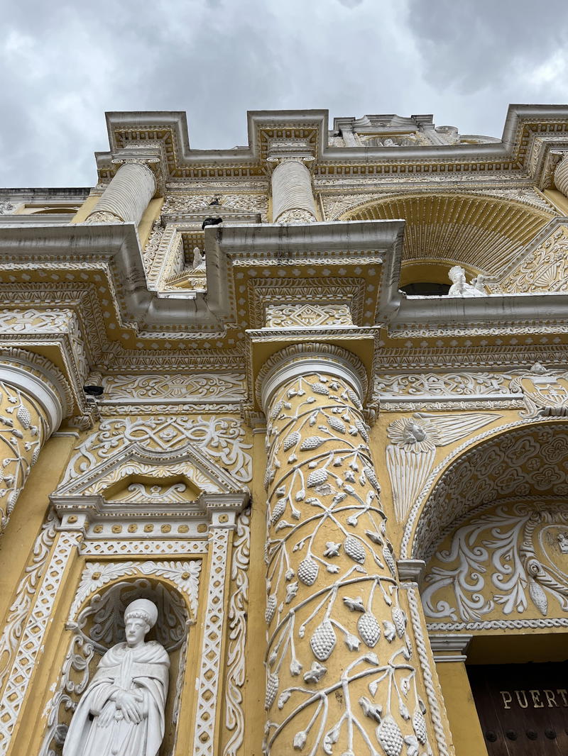 An ornate building with a statue on the front.