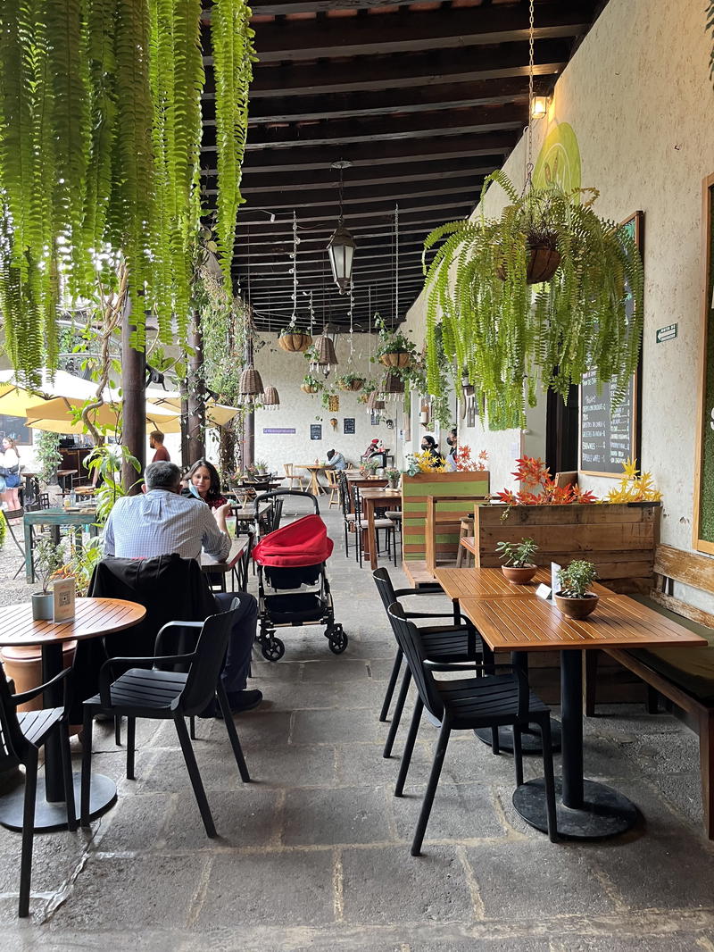 A group of people sitting at tables in a restaurant.