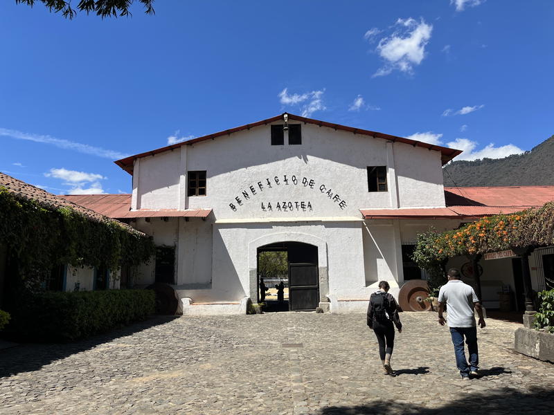 Two people walking down a cobblestone street in Guatemala.