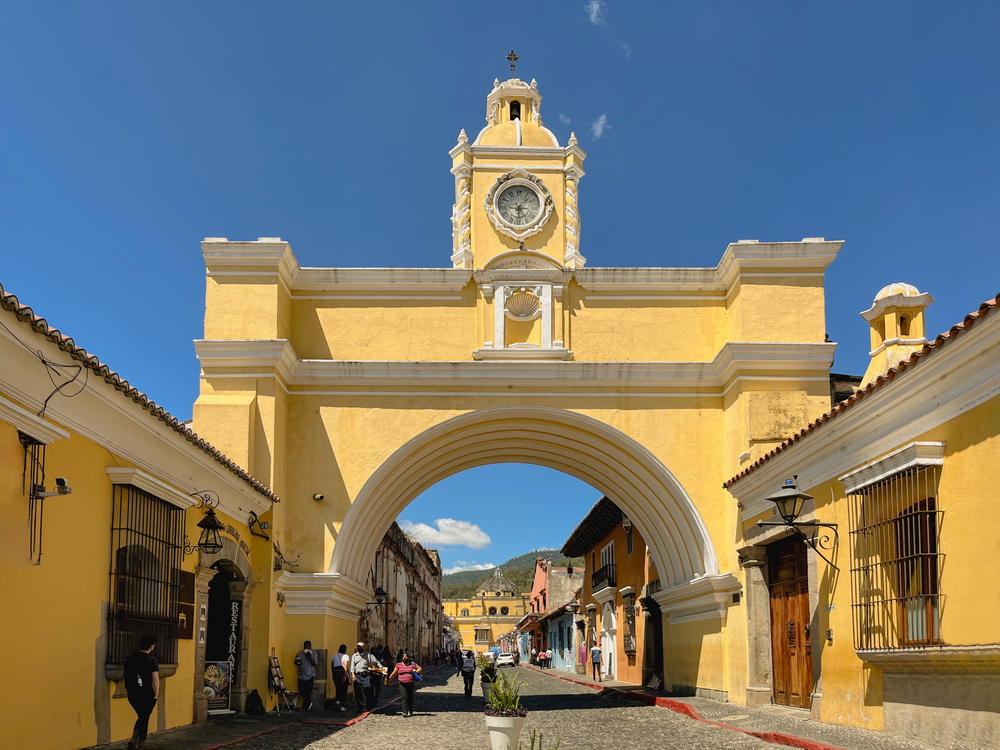 A yellow clock tower building in Guatemala.