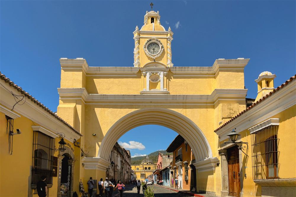 A yellow clock tower building in Guatemala.