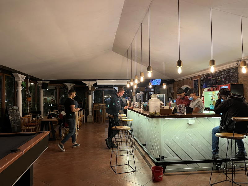 A group of people sitting at a bar in a Guatemalan restaurant.