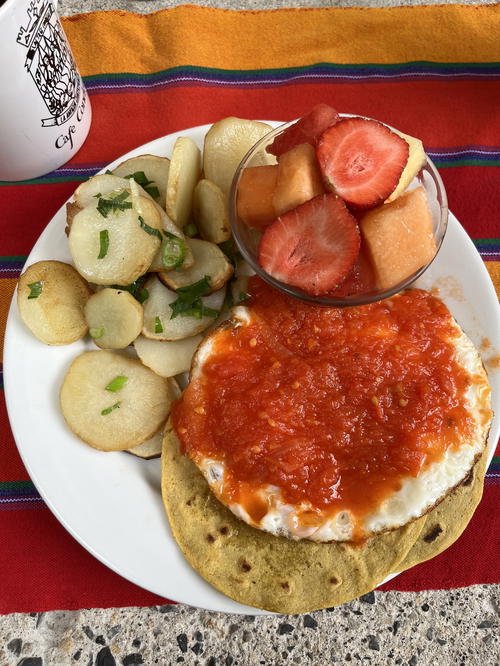 A plate of food on a striped tablecloth.