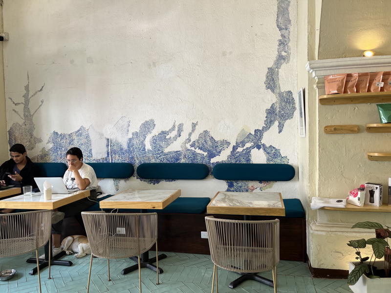 Two people sitting at a table in a coffee shop in Guatemala.