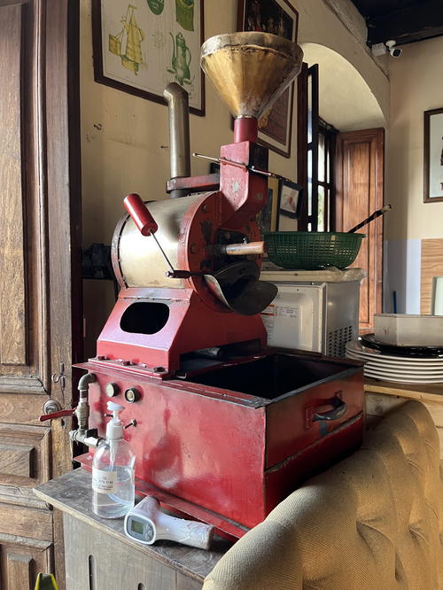 A Guatemala-themed coffee grinder sitting on a table in a room.