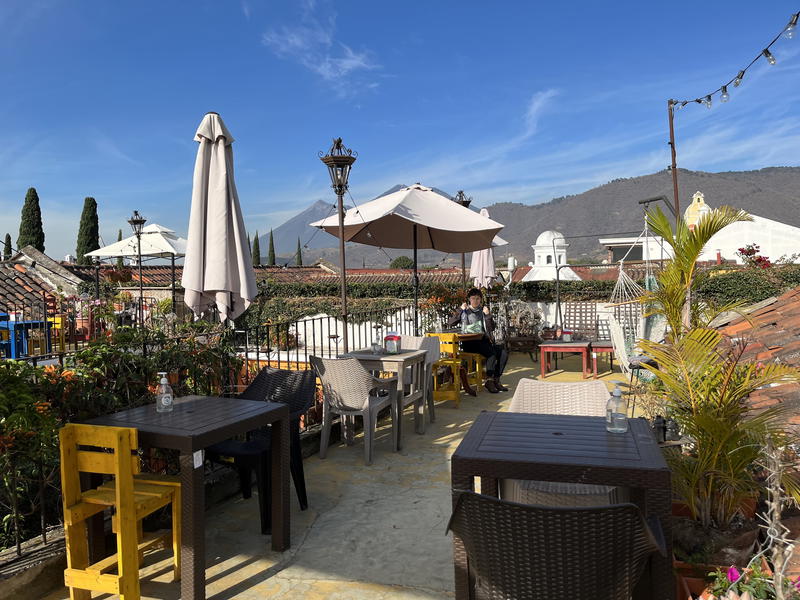 A rooftop restaurant in Guatemala with tables and chairs.