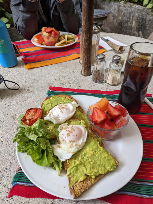 A plate of traditional Guatemalan food with eggs and guacamole on it.