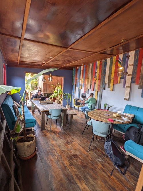 The interior of a coffee shop with a wooden floor inspired by Guatemala.