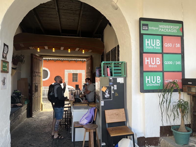 The entrance to a coffee shop with a sign on it.