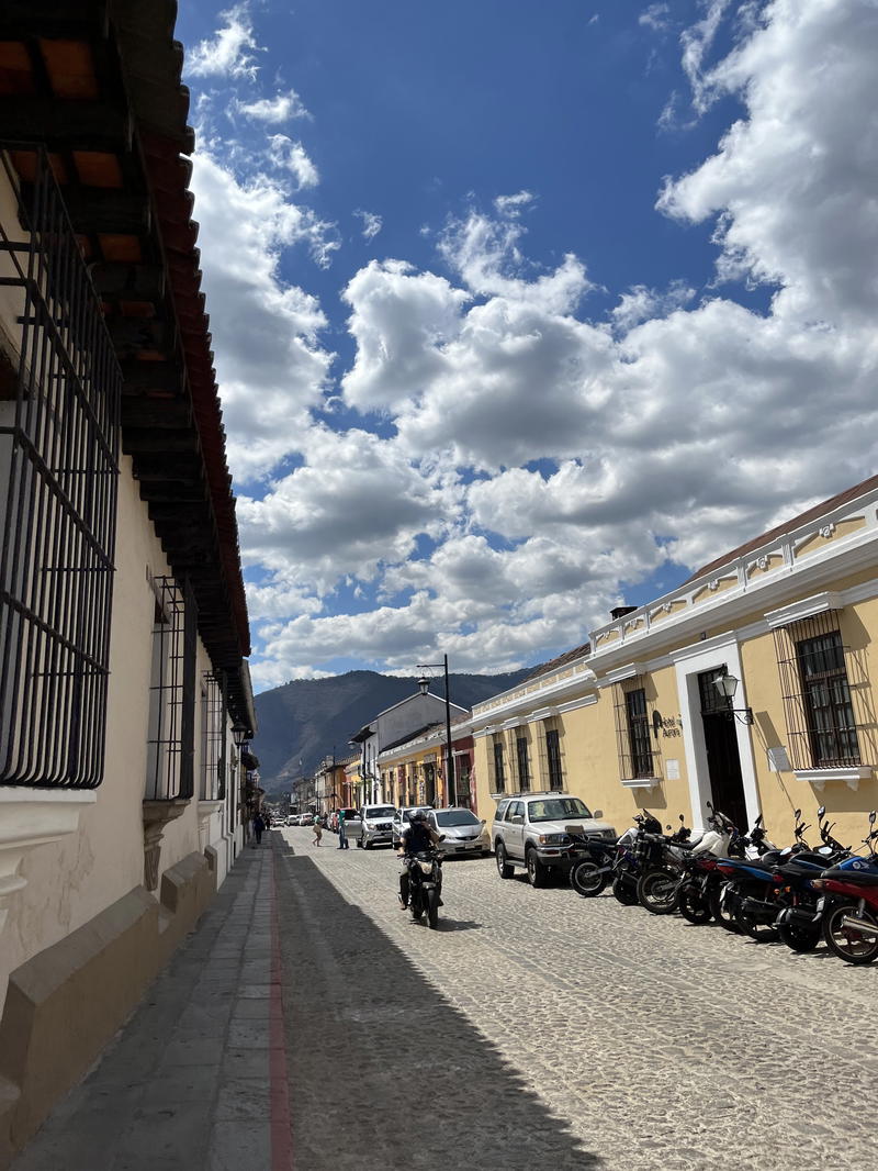 A street with motorcycles parked in front of a building.
