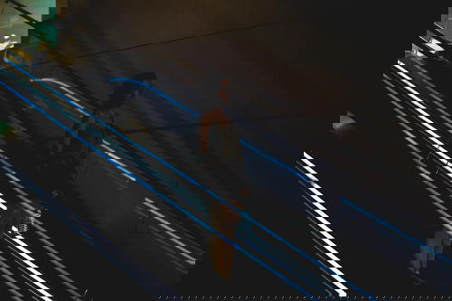 A woman is descending the escalator in Hong Kong.