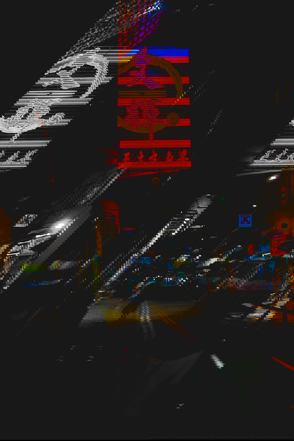 Vertical image of Hong Kong with neon signs