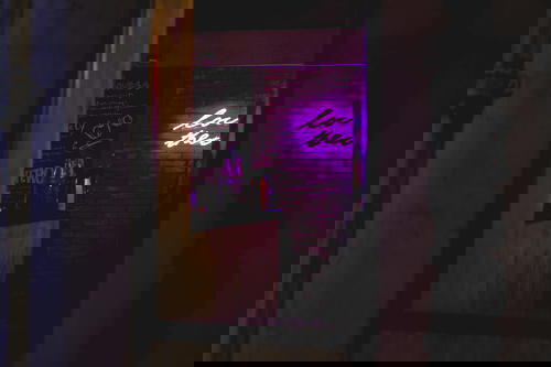 A neon sign adorns a bar in Hong Kong.