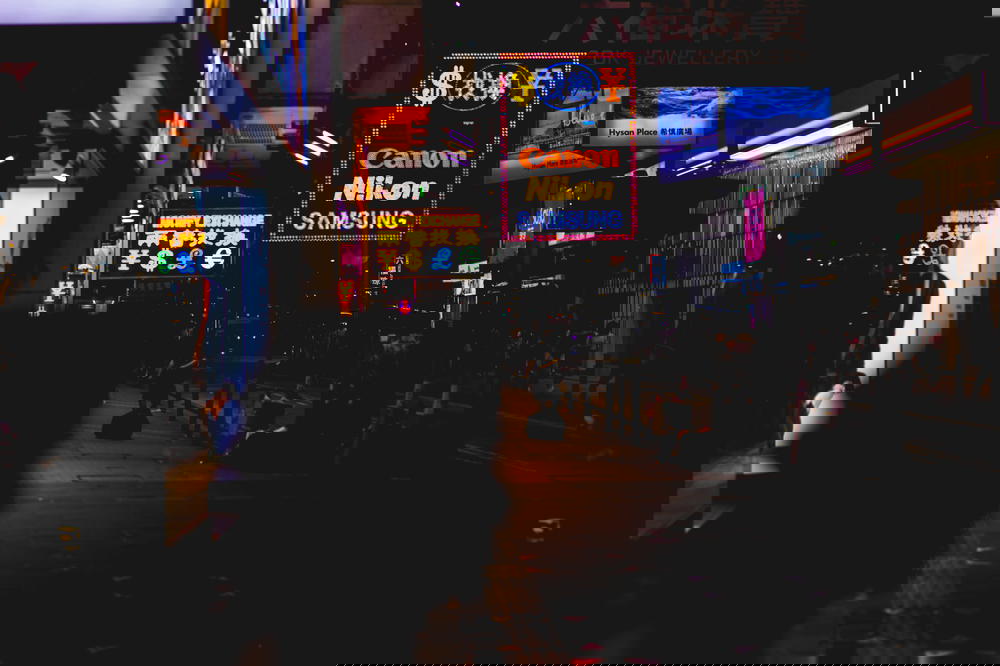 Old neon signs from camera brands like Nikon, Canon and Samsung