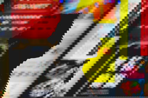 A silhouette of a woman in front of Hong Kong advertisements.