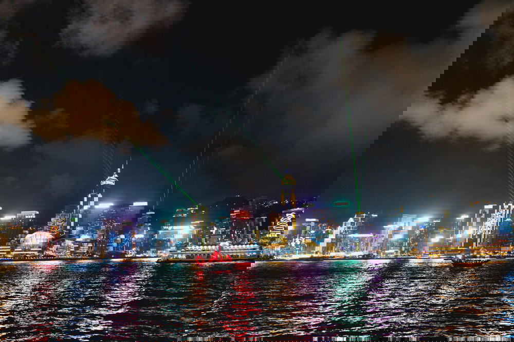View of the colorful Hong Kong skyline at night with a lazer light show