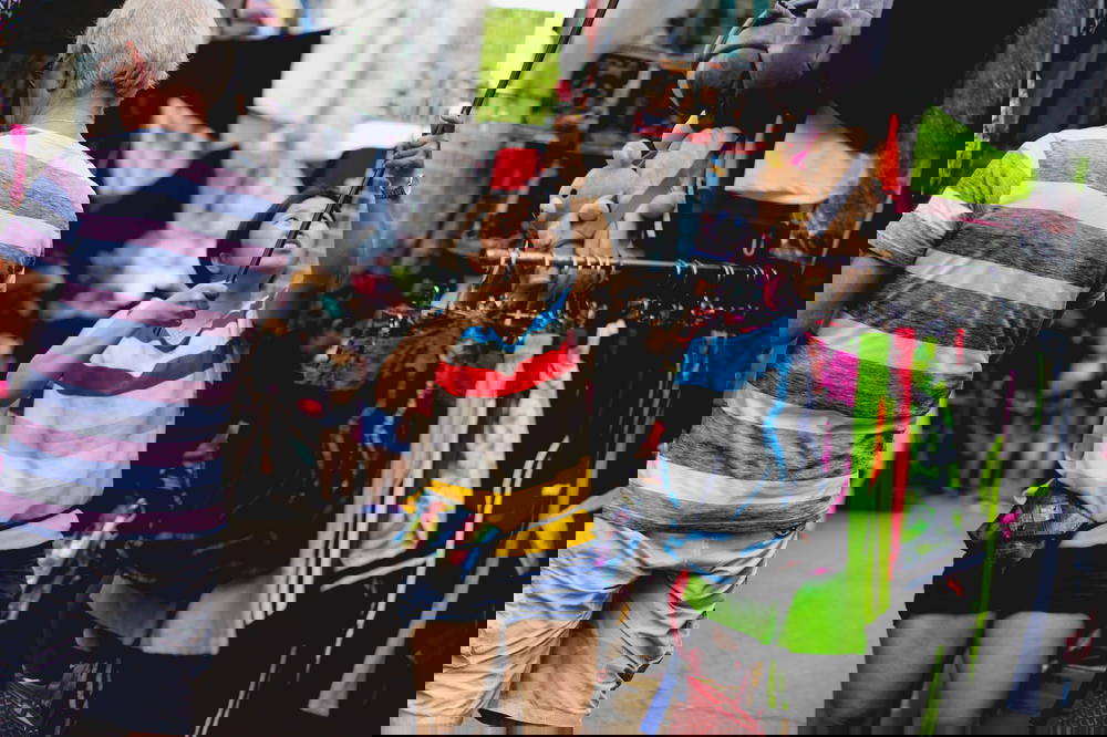 Woman hanging an item high up with a pole in a Hong Kong market