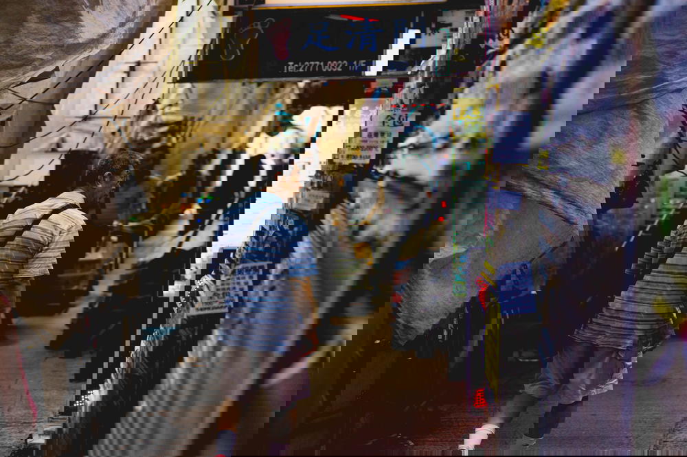 Man walking through a narrow market alley