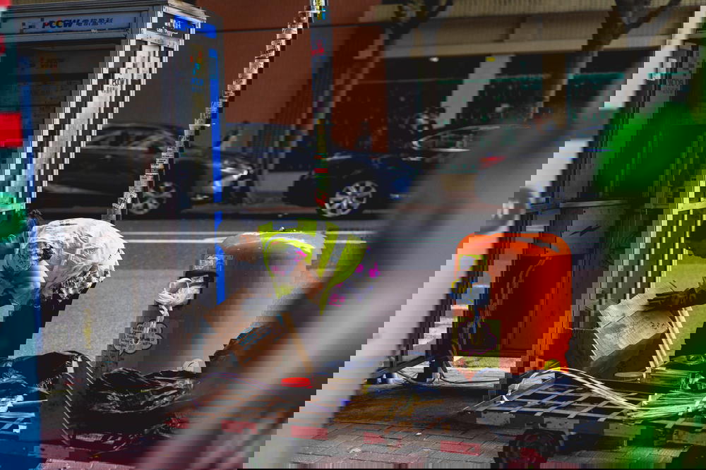 Hong Kong city worker breaking down a box