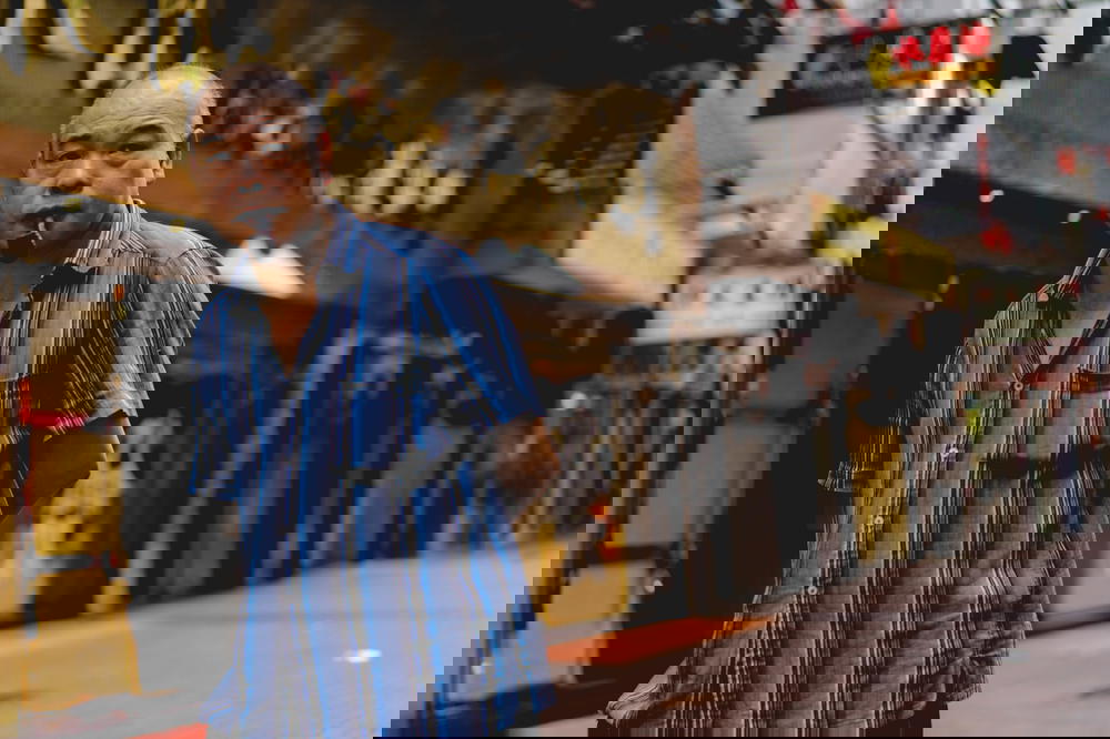 Man looking in the distance smoking a pipe in Hong Kong