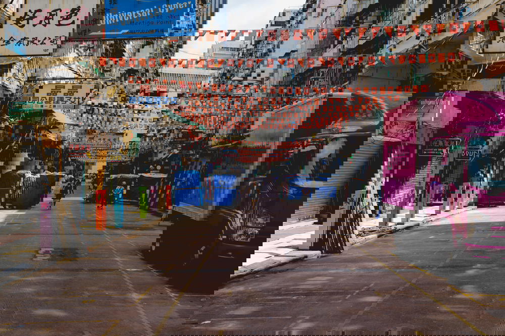 Empty street with street decorations and a pink truck