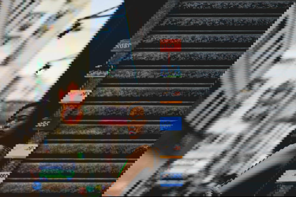 Girl looking to the side of a metal store front in Hong Kong