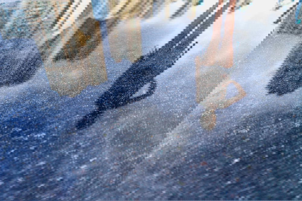 The reflection of a person in a puddle of water in Hong Kong.