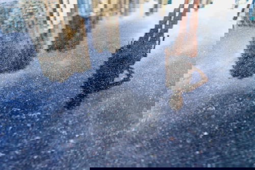 The reflection of a person in a puddle of water in Hong Kong.