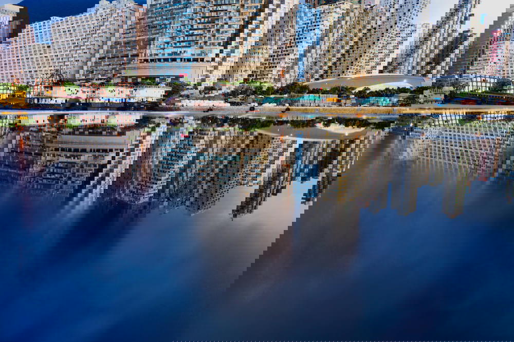 Hong Kong cityscape mirrored in water.