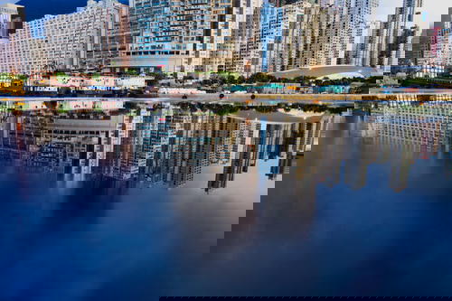 Hong Kong cityscape mirrored in water.