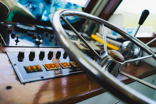 A close up of a steering wheel on a boat in Hong Kong.