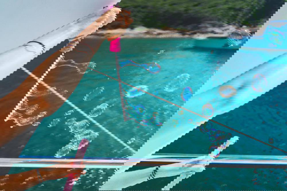 Blowing bubbles on a boat in the ocean