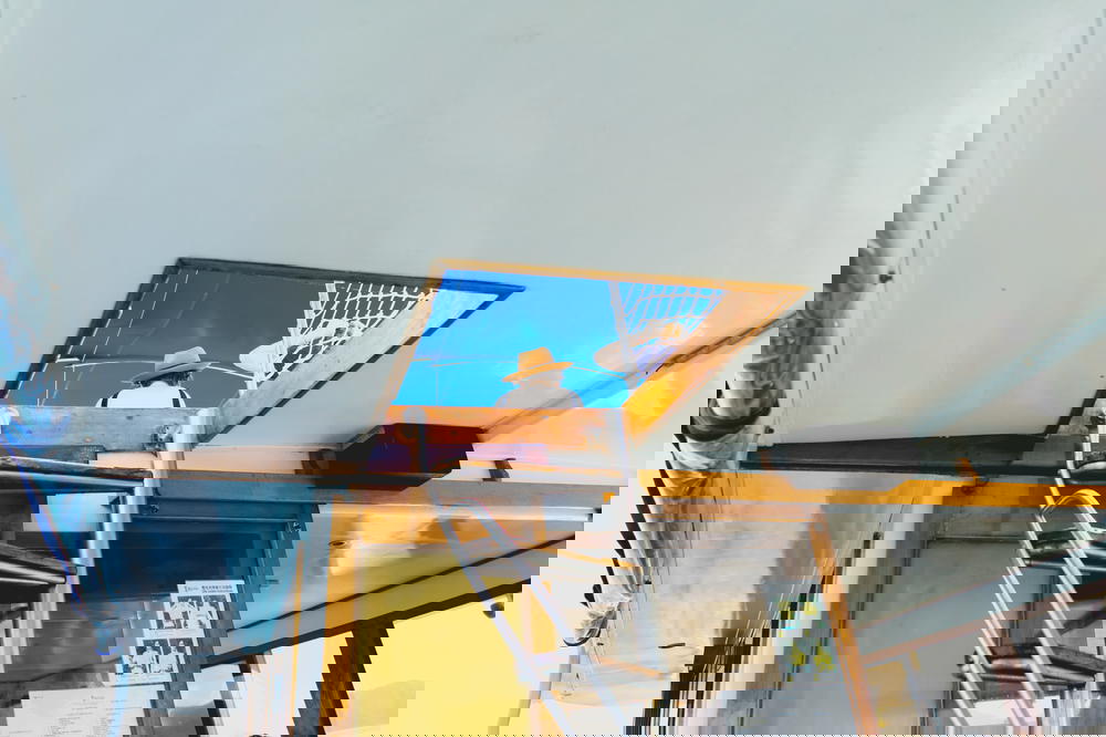 The skylight of a junk boat with a girl on the roof