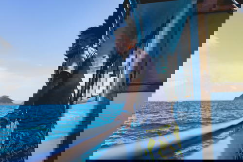 A man in Hong Kong gazes out at the vast ocean from his boat.