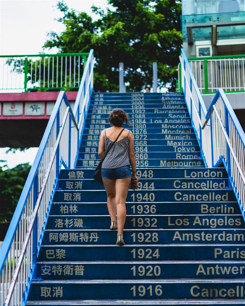 A woman is climbing stairs in Hong Kong.