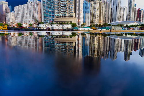 Hong Kong city reflected in water.