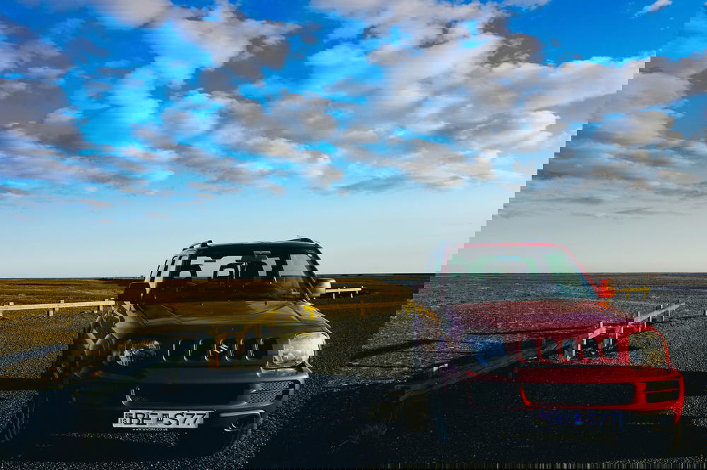 A red jeep parked in Iceland.