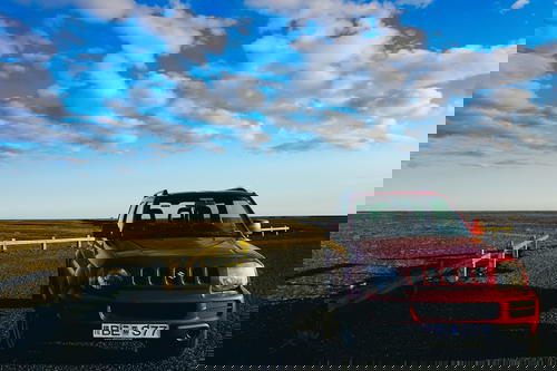 A red jeep parked in Iceland.