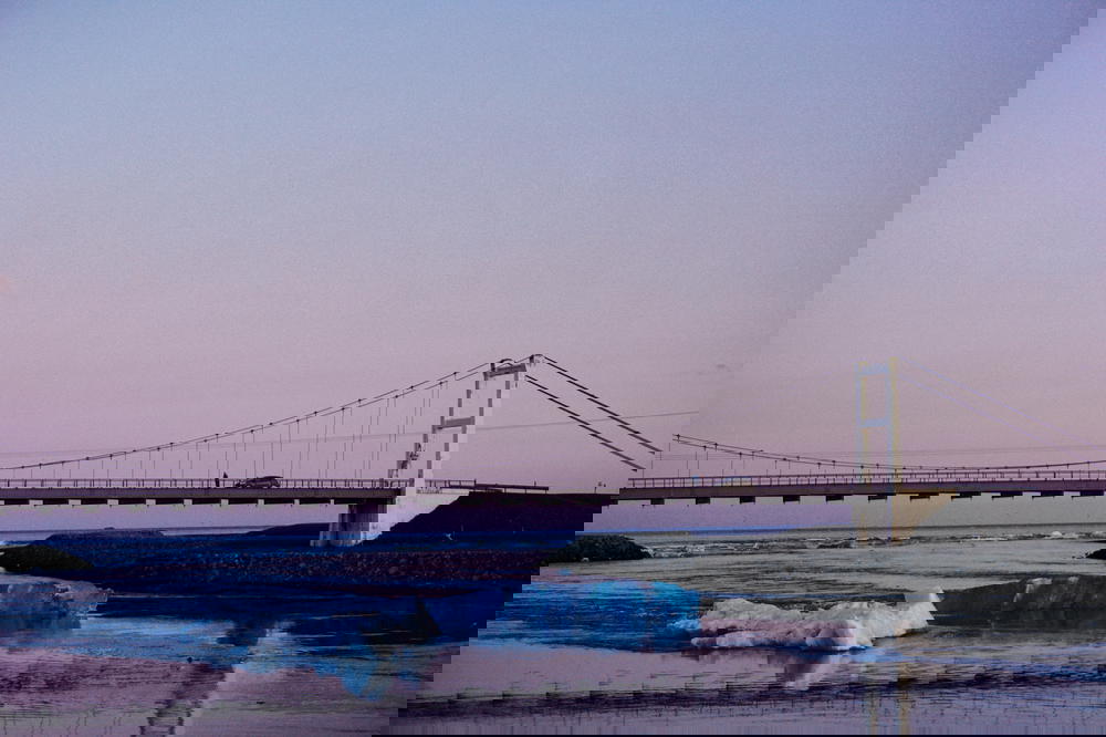 A bridge in Iceland over a body of water.