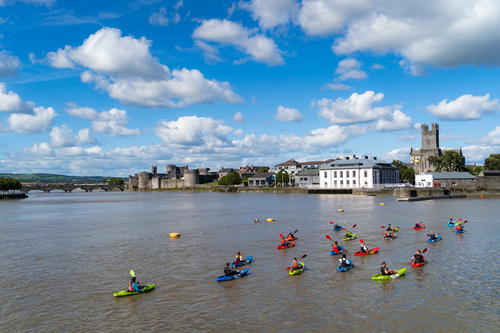 A group of people on canoes navigating through Ireland's Wild Atlantic Way.