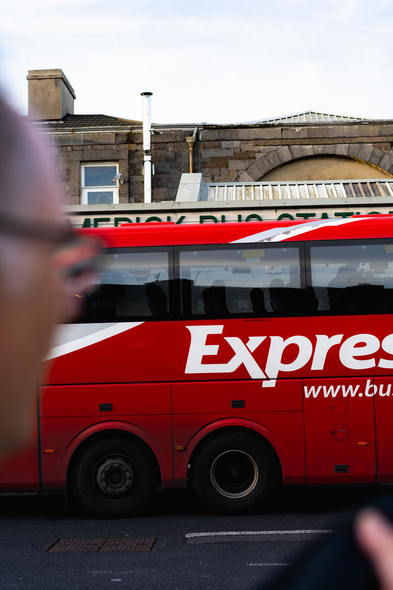 A red express bus parked along the Wild Atlantic Way in Ireland.
