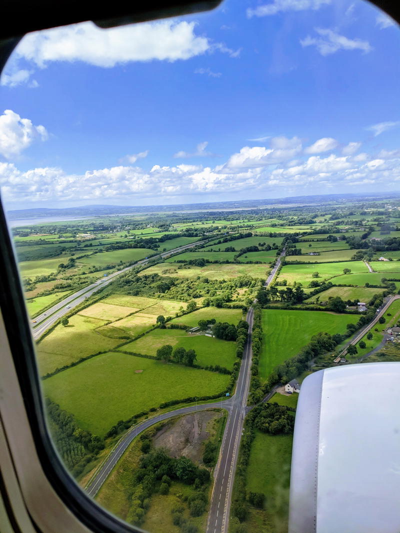 A view from the airplane window capturing the breathtaking Wild Atlantic Way in Ireland.