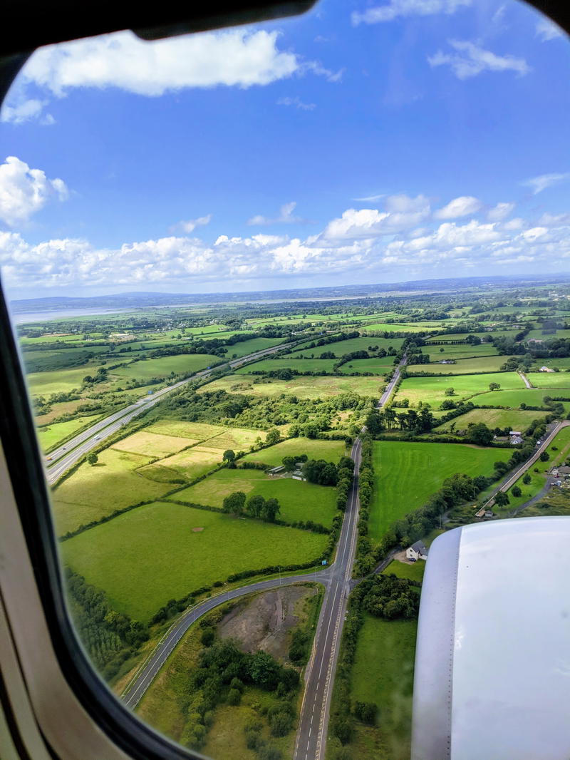 A view from the airplane window capturing the breathtaking Wild Atlantic Way in Ireland.