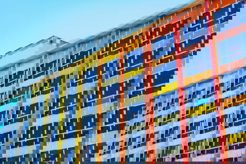 A colorful building in Israel with vibrant windows.