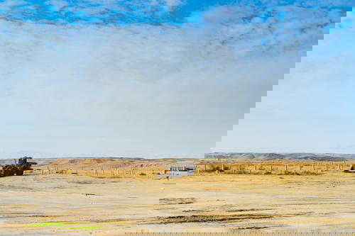 A bulldozer in the middle of the Israeli desert.