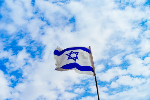 Israel flag on a blue sky