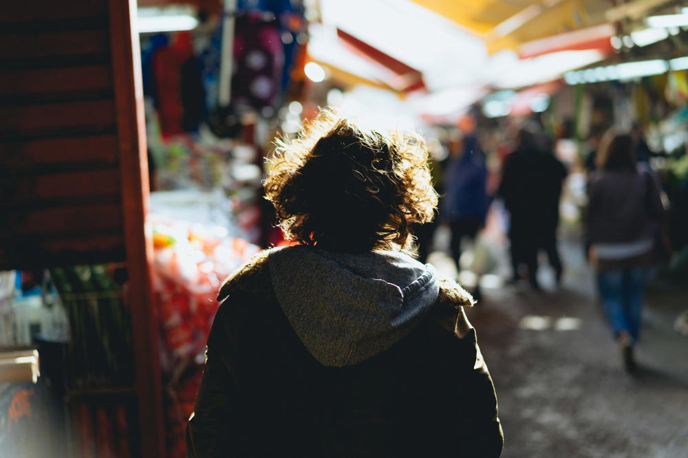 A woman walking down a street in Israel.