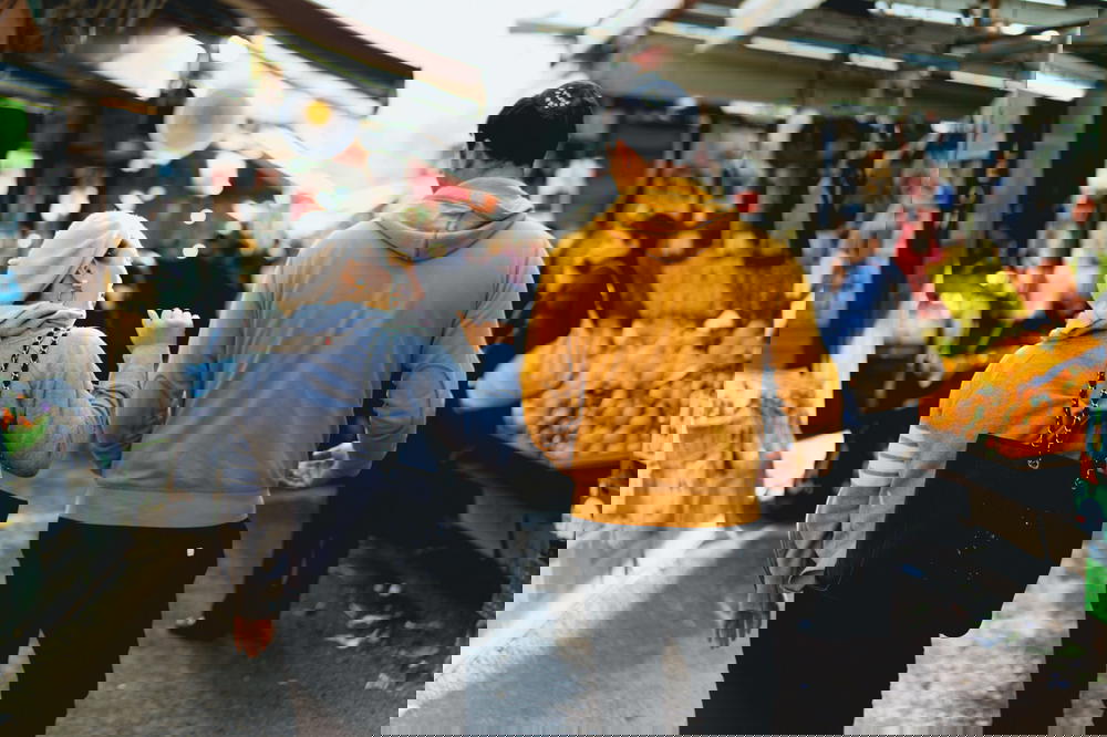 A couple strolling through a vibrant market in Israel.